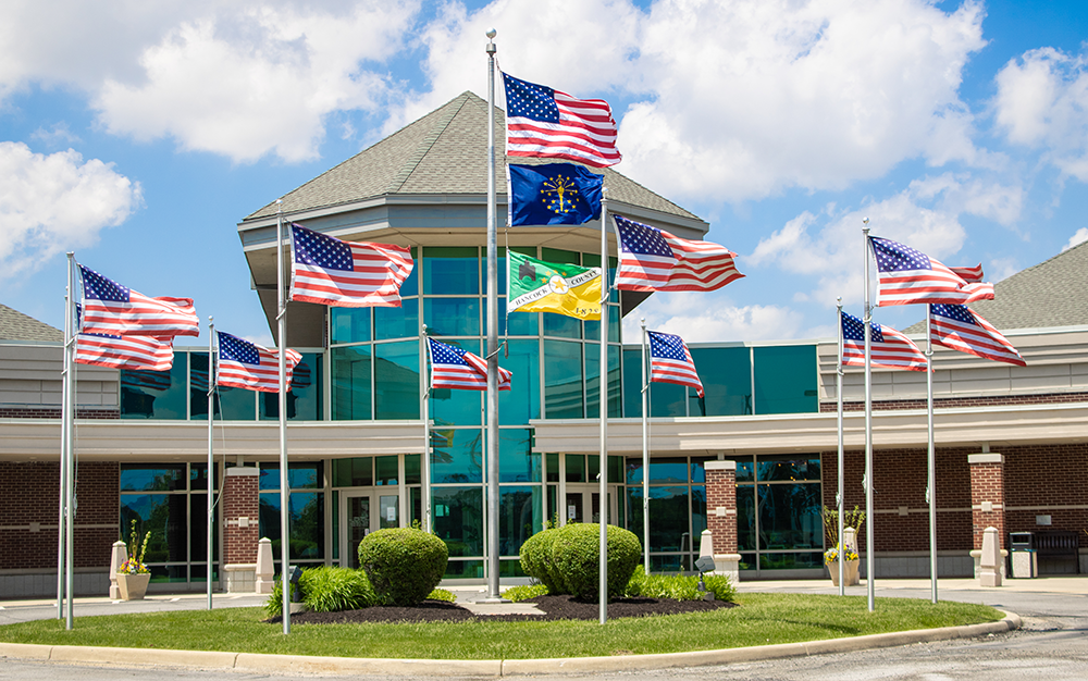 Main Library exterior displaying multiple US flags