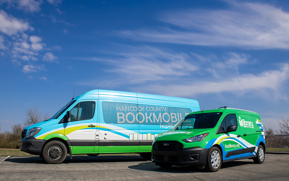 Two bookmobile vehicles parked next to each other