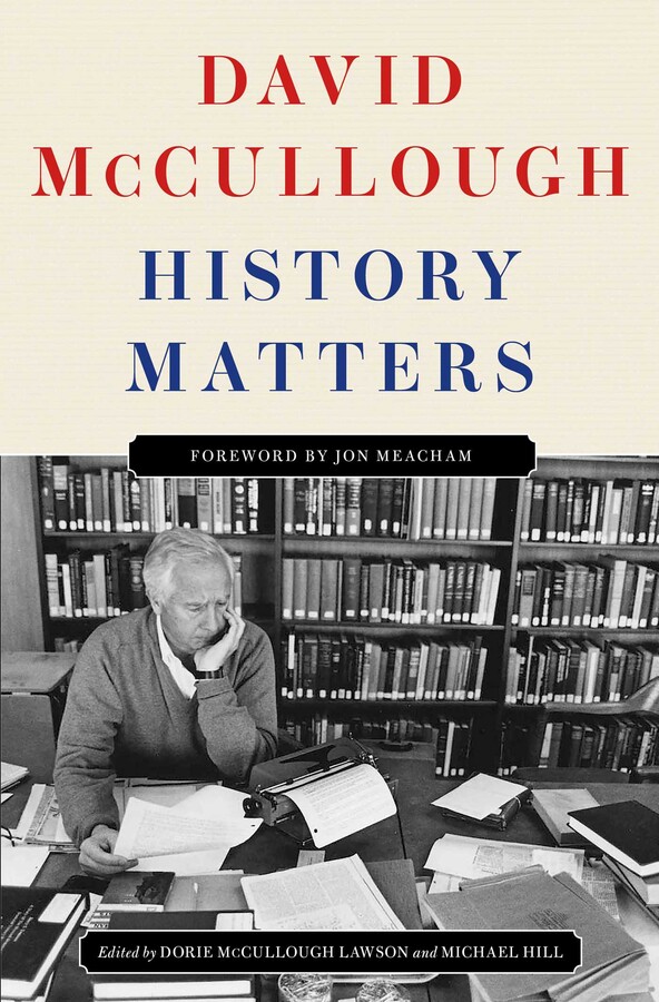 The author at his desk surrounded by papers and books