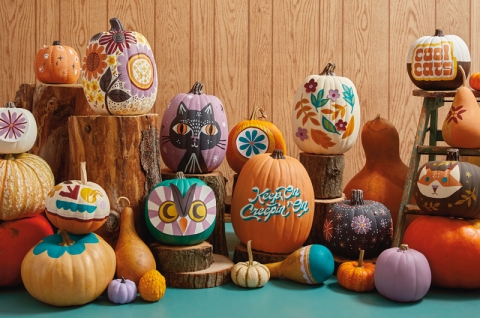 Piles of painted pumpkins of different designs