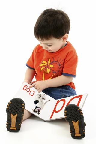 a child reading a book in storytime in New Palestine