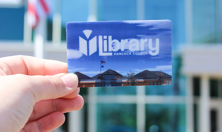 Someone holding up a Library Card